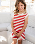 Young girl in a red and white striped outfit on a boat