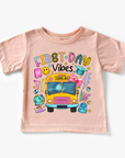 Pink t-shirt with colorful graphics and text on a white background