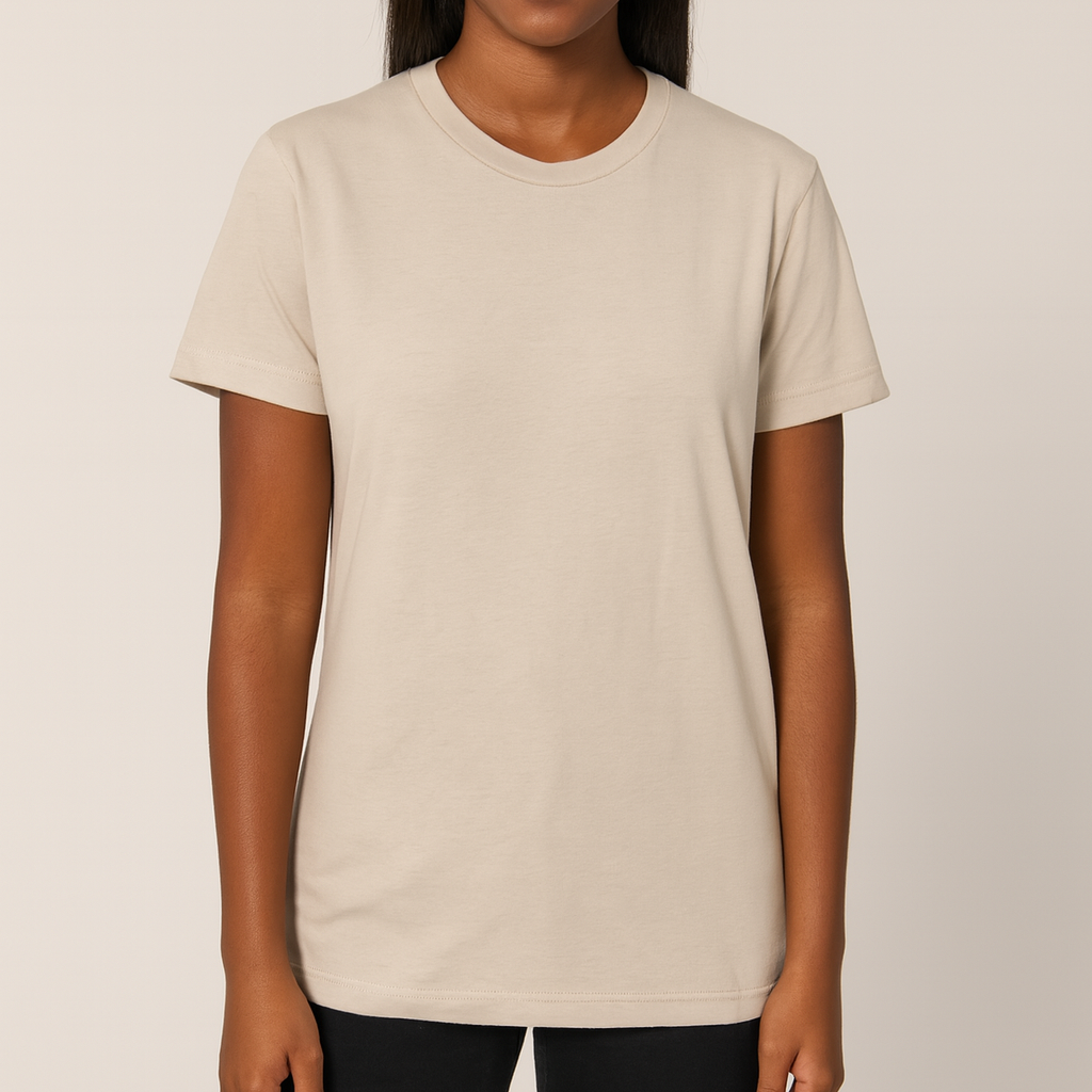 Dark-skinned female model wearing a neutral Bella + Canvas 3001C Unisex Jersey T-Shirt on a beige background — soft cotton blank ideal for custom printing by Lumiere Vive.