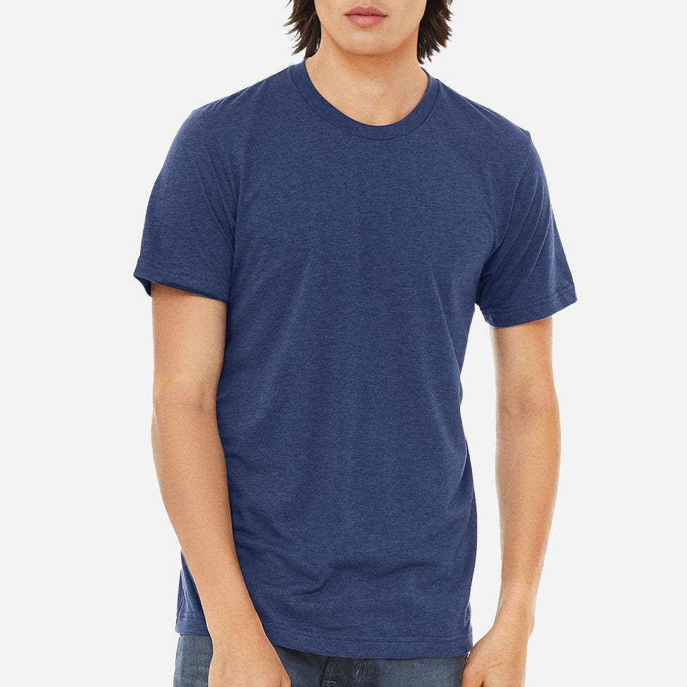 Male model wearing a navy Bella + Canvas 3413C Triblend T-Shirt on a white background — soft lightweight tri-blend blank ideal for custom printing by Lumiere Vive.