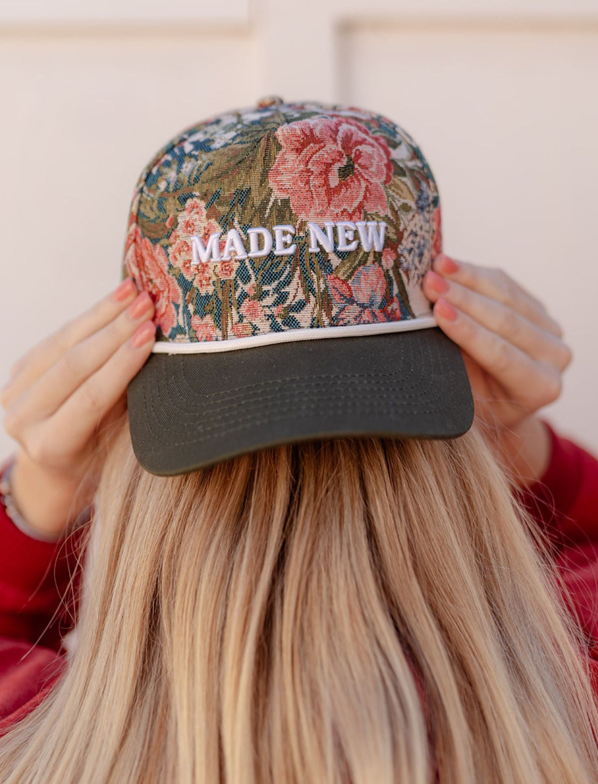 Close-up of the Made New hat showing colorful floral fabric, embroidered lettering, and a contrasting dark brim
