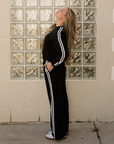 Side view of varsity stripe set showing sleeve and pant-leg stripes