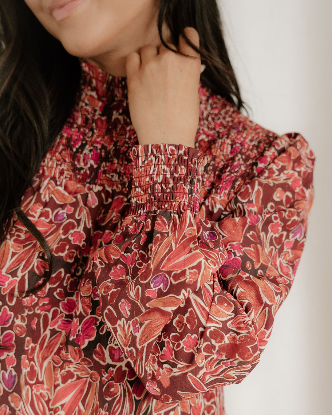 Close-up of Lilith floral dress with shirred high neckline