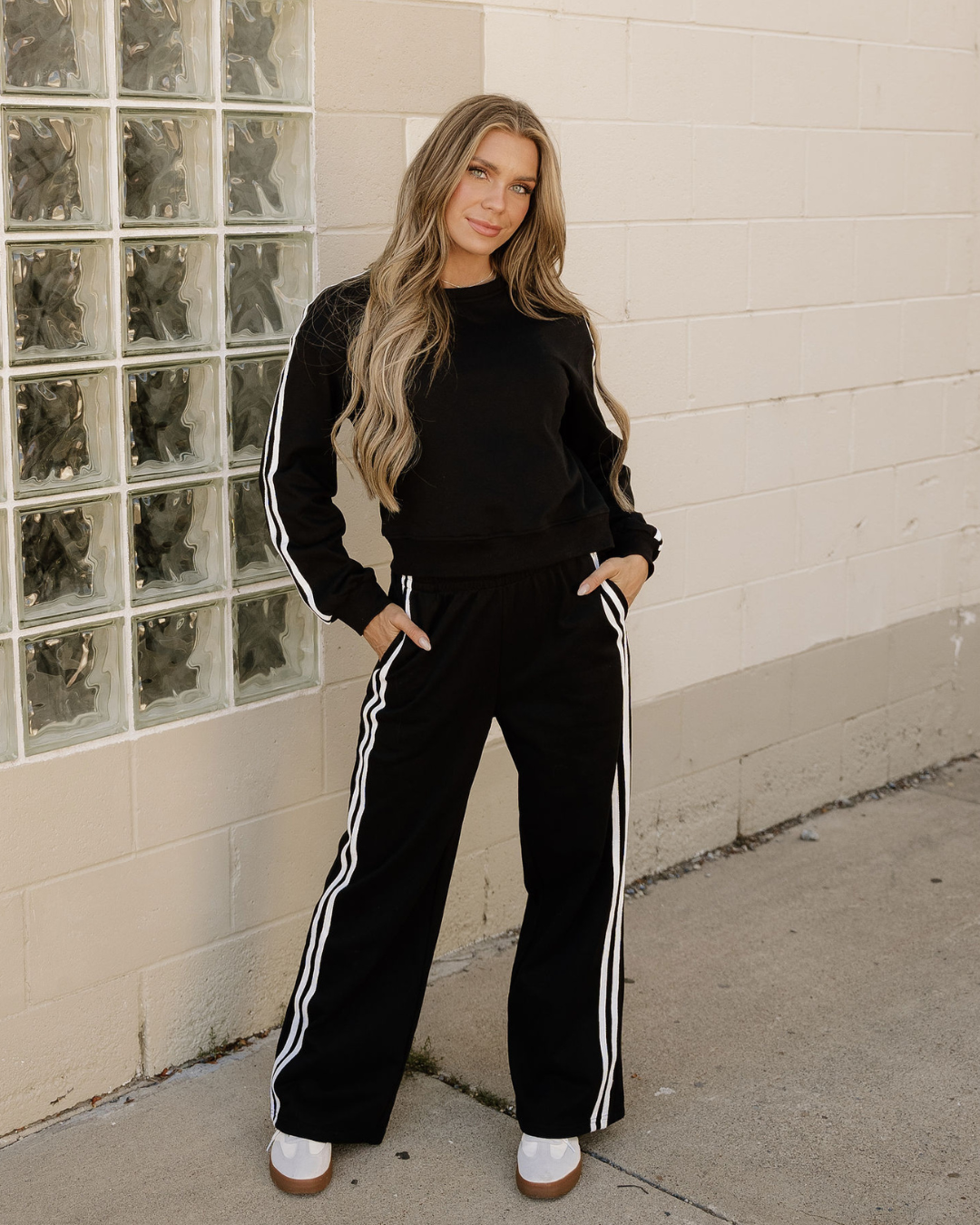 Front view of black striped pullover and matching sweatpants