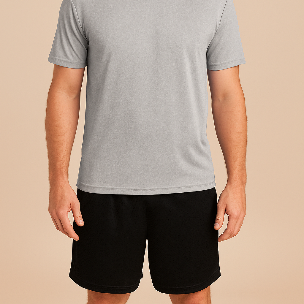 Male model wearing black Badger 7207 Pro Mesh Athletic Shorts on a neutral beige studio background — breathable performance blank ideal for custom printing by Lumiere Vive.