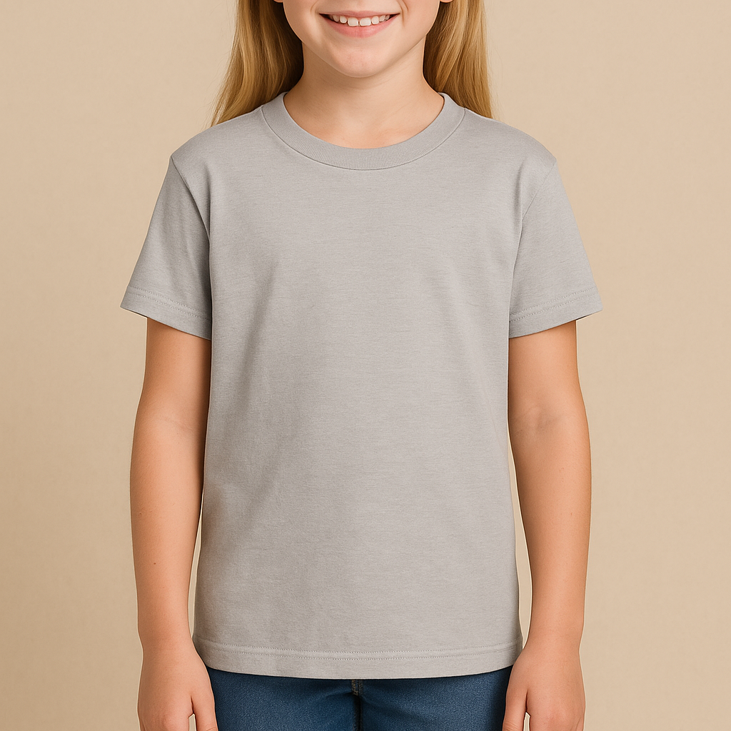 Young girl wearing a light grey Gildan 8000B Youth DryBlend T-Shirt on a neutral beige studio background — soft cotton-poly tee ideal for custom printing by Lumiere Vive.