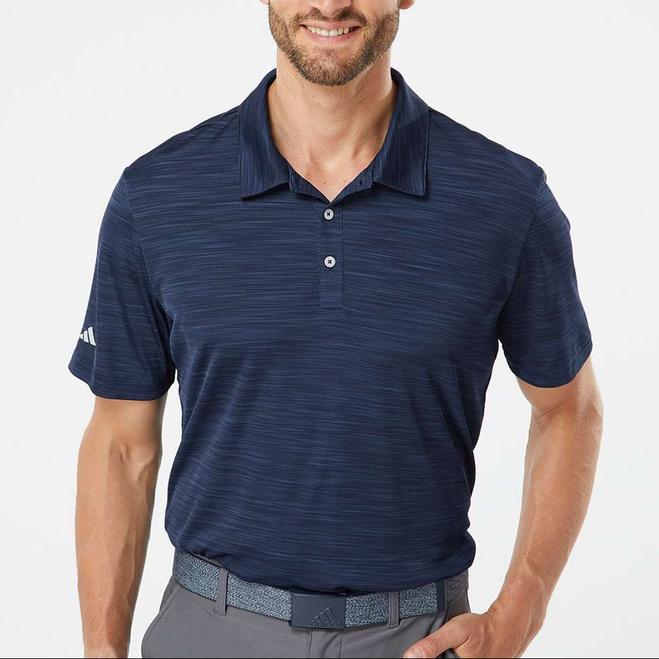 Man wearing a navy blue Adidas A402 Men’s Blend Polo on a neutral background — premium moisture-wicking performance polo ideal for embroidery or custom branding by Lumiere Vive.