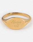 Gold ring with 'Above all' engraving on a white background