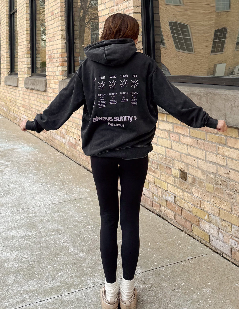Model wearing black Always Sunny With Jesus hoodie with black leggings