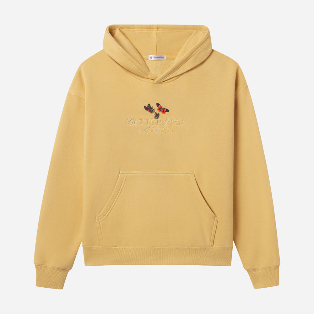 Yellow hoodie with butterfly design on a light gray background