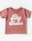 Pink t-shirt with 'Big Sister' text on a white background