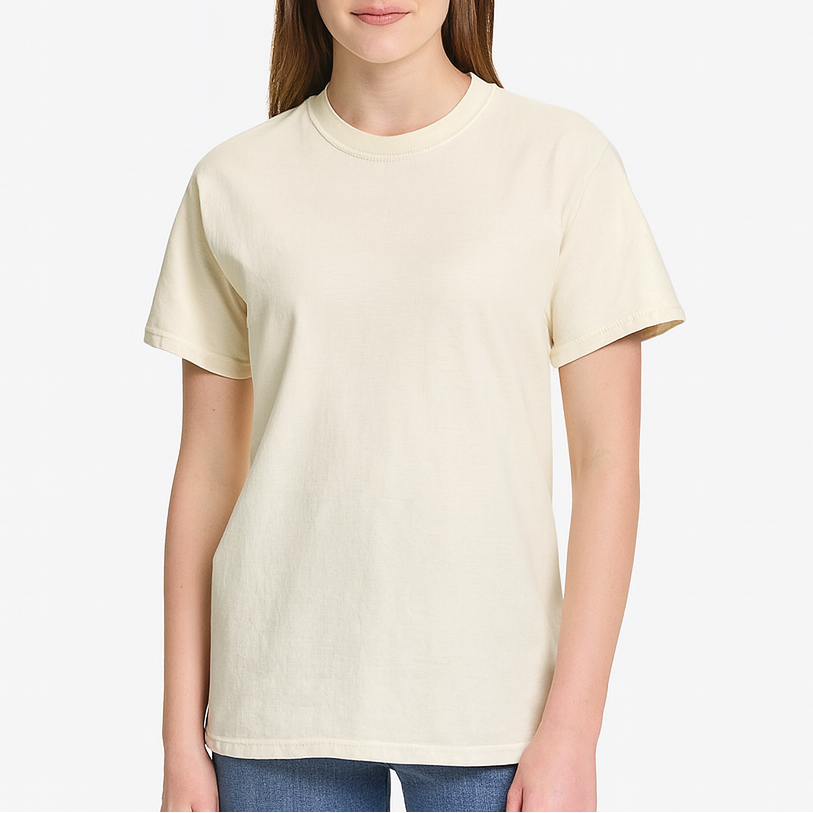 Young woman wearing an ivory Comfort Colors Heavyweight T-Shirt, styled casually with a relaxed unisex fit — ideal for custom printing and everyday comfort by Lumiere Vive.