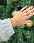 Delicate Cross Link Bracelet styled with a cream sweater
