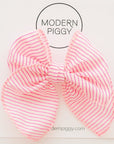 Pink striped hair bow with 'Modern Piggy' branding on a white background