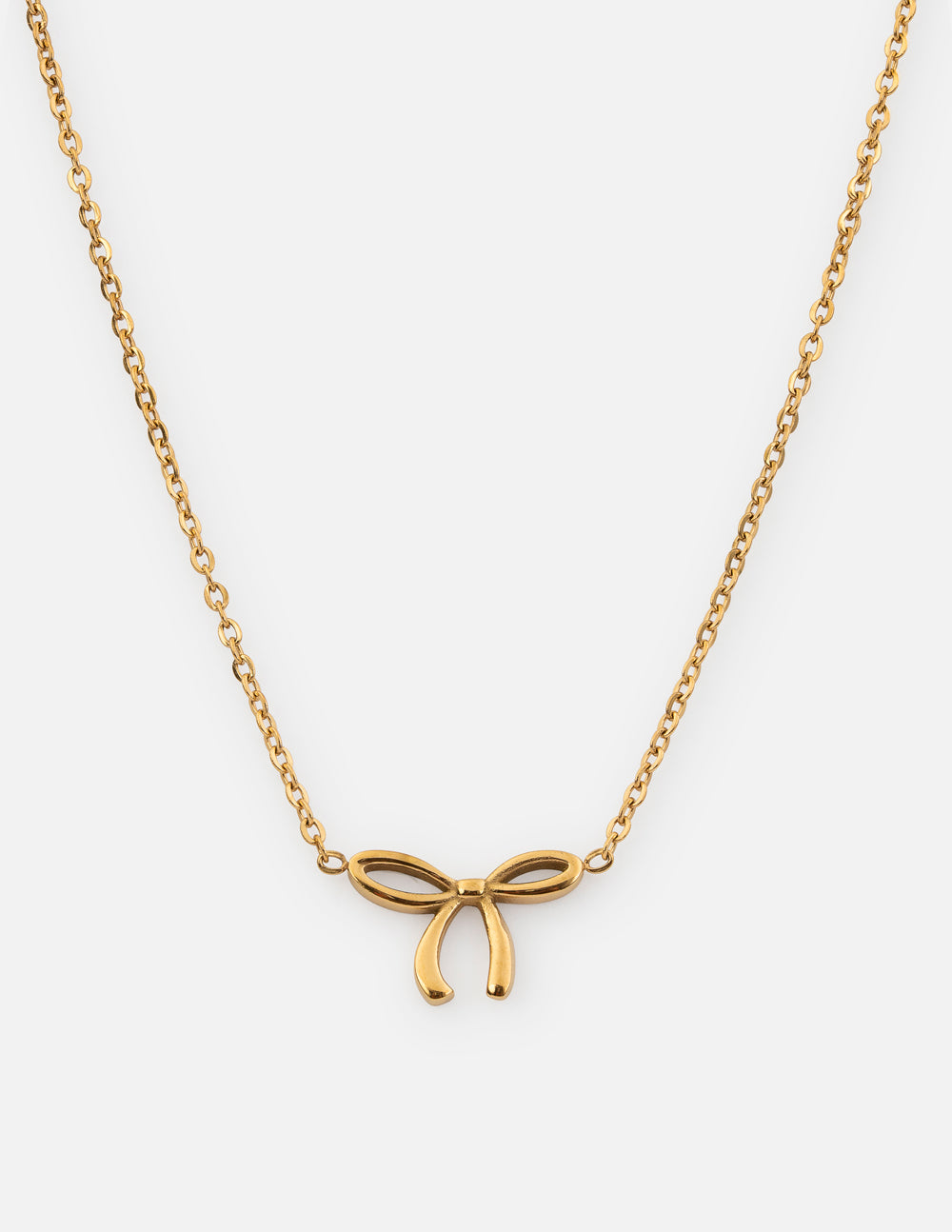 Dainty gold-tone bow necklace with a fine link chain on a white background