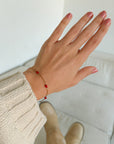 Dainty Love Link Bracelet worn on a wrist, showing delicate red hearts