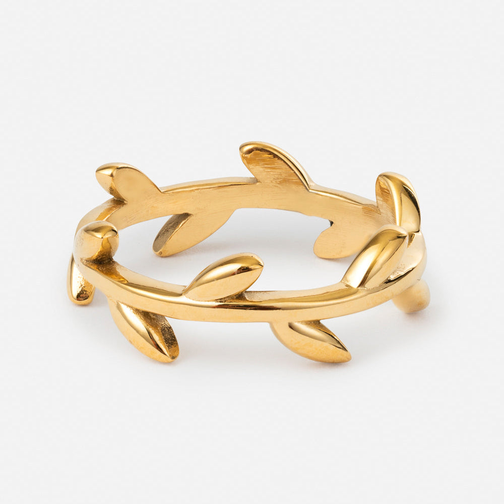 Gold bracelet with leaf design on a white background