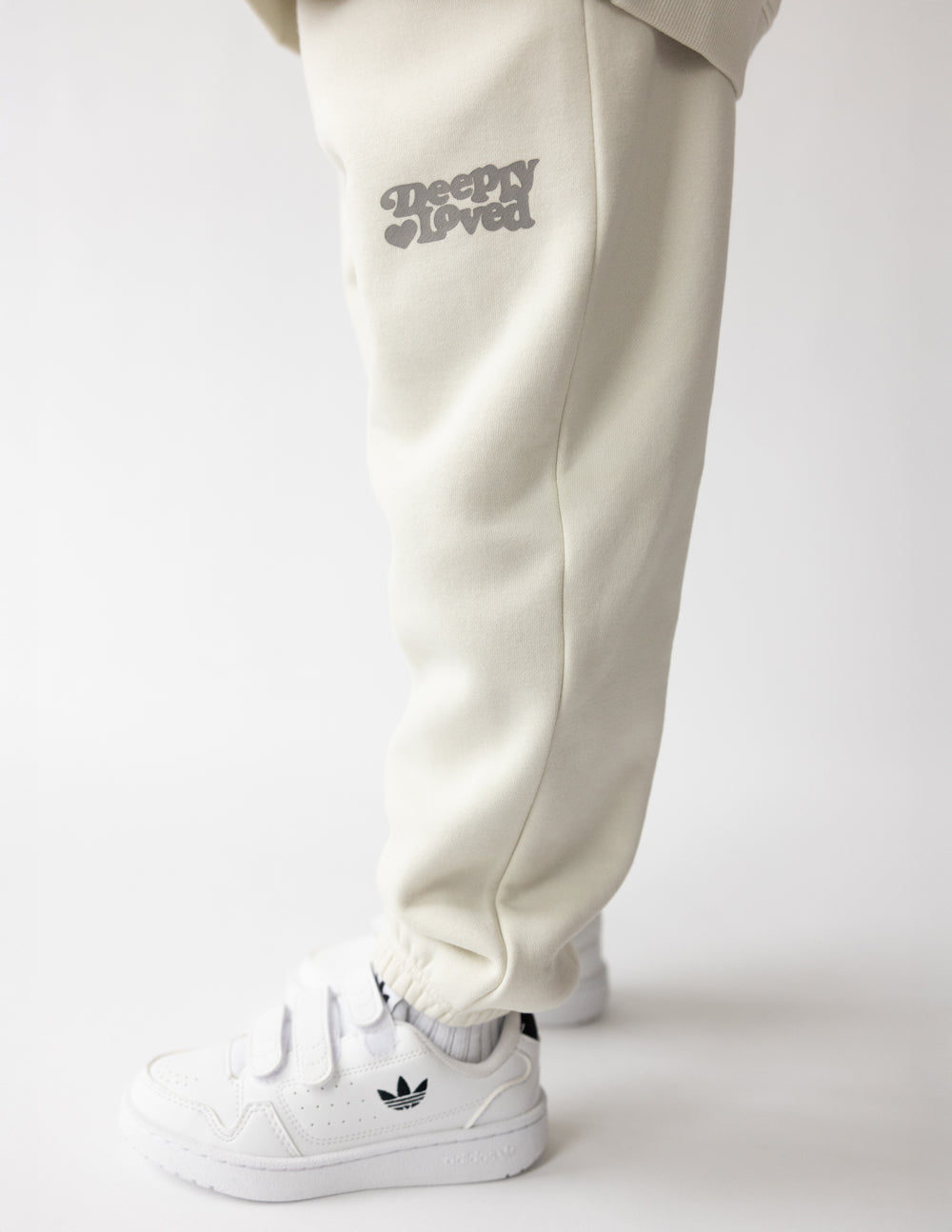 Child wearing Moonstone sweatpants with a coordinating sweatshirt outdoors on a dirt path
