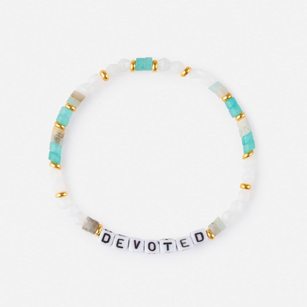 Bracelet with 'DEVOTED' beads on a white background