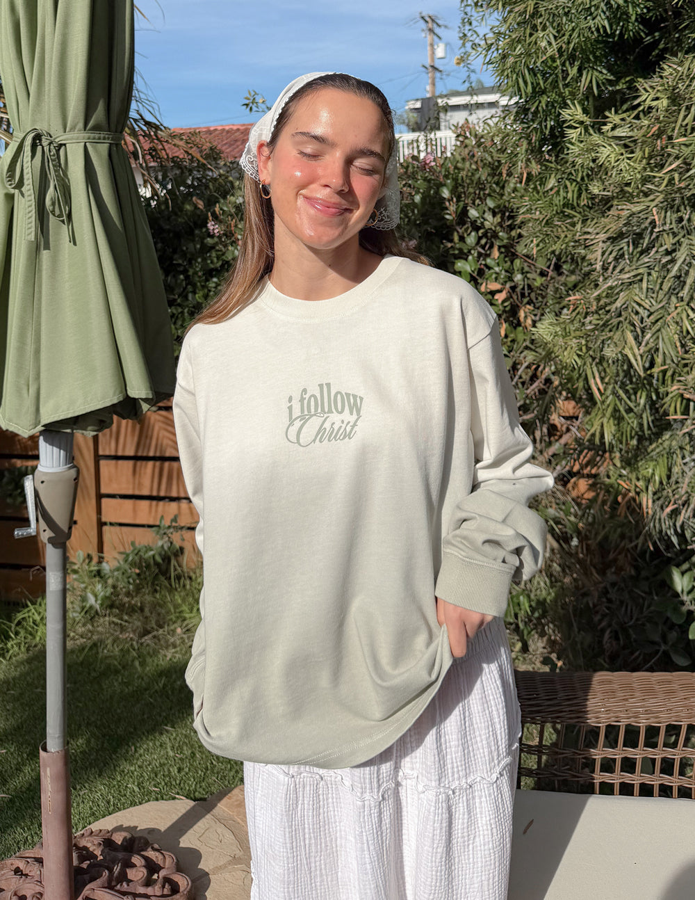 Model wearing Follow Christ heavyweight long-sleeve tee in Green Mist Ombre
