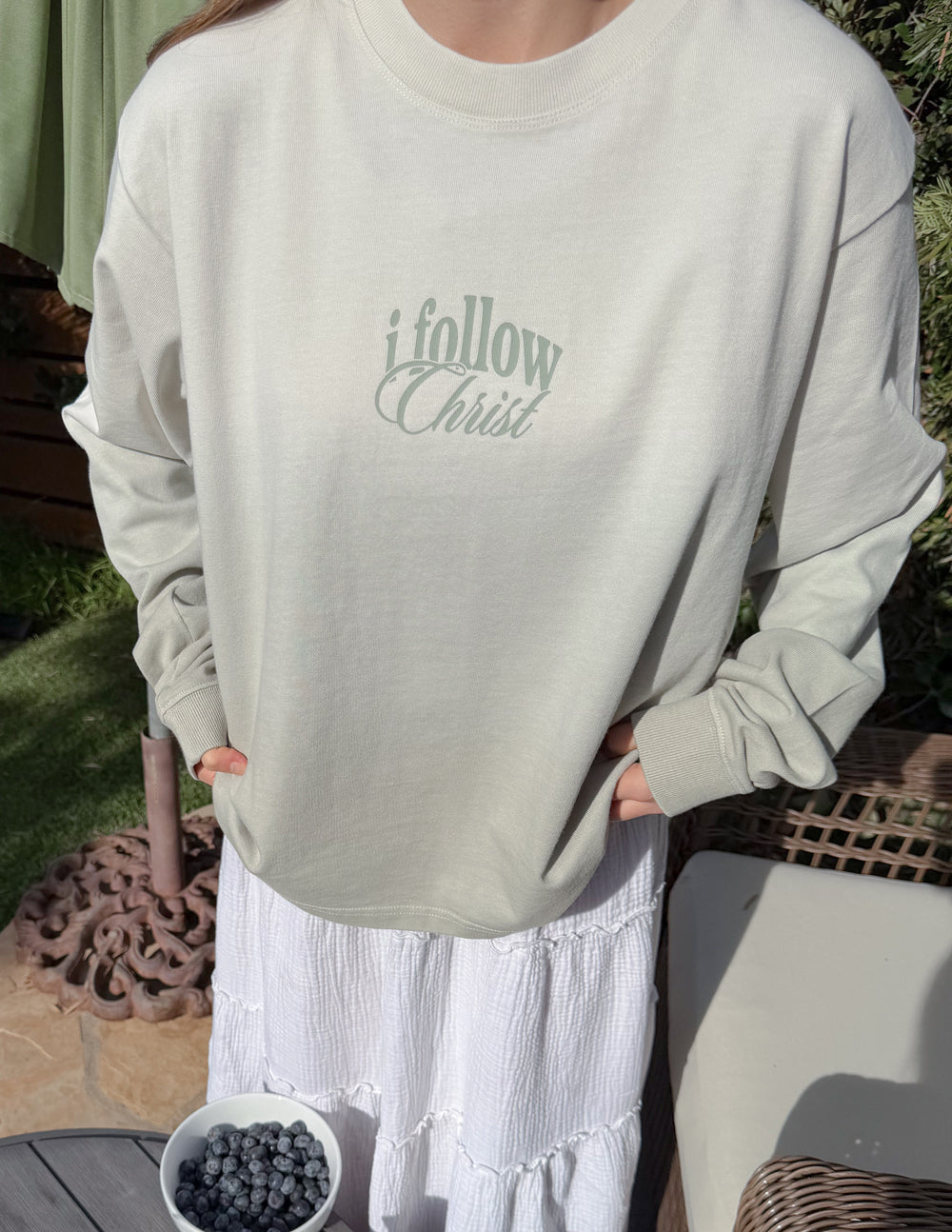 Close-up of Follow Christ lettering on the front of the heavyweight cotton tee