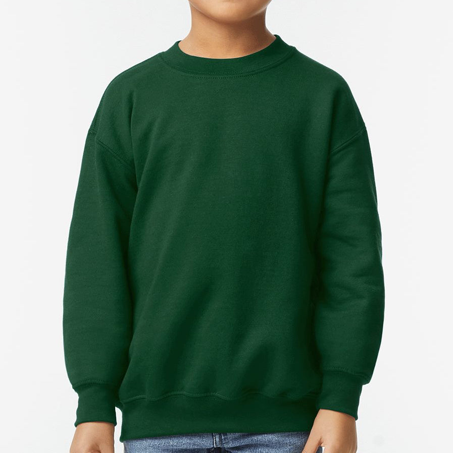 Young boy wearing a forest green Gildan Youth Heavy Blend Crewneck Sweatshirt with a soft fleece interior and classic relaxed fit — perfect for custom prints and cozy everyday wear.