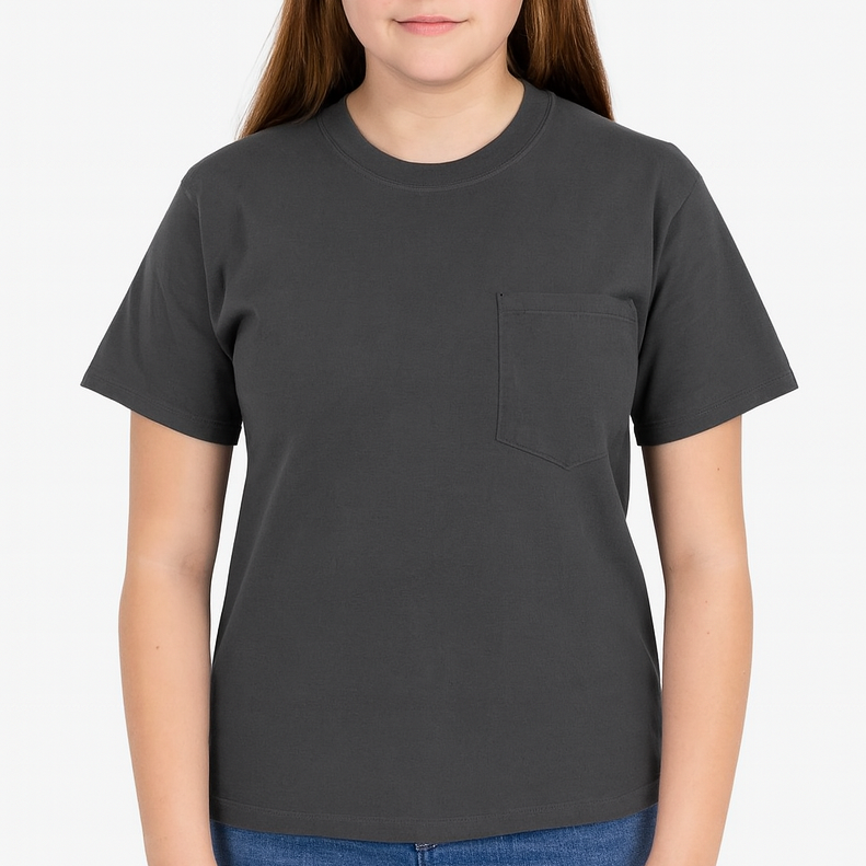 Young woman wearing a charcoal Gildan Heavy Cotton Pocket T-Shirt, showcasing a relaxed unisex fit and durable fabric — ideal for custom printing by Lumiere Vive.