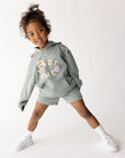 Child modeling God Made Me kids shorts in Millstone Grey with a coordinating hoodie