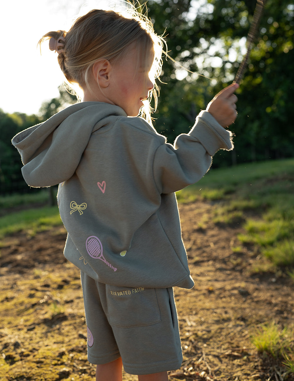Child wearing Millstone Grey God Made Me kids shorts outdoors