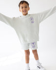 Child wearing the Icicle God’s Plan Racing hoodie with arms extended and coordinating shorts.