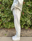 Side view of the God’s Plan Racing Icicle Sweatpants showing the purple upper-leg graphic