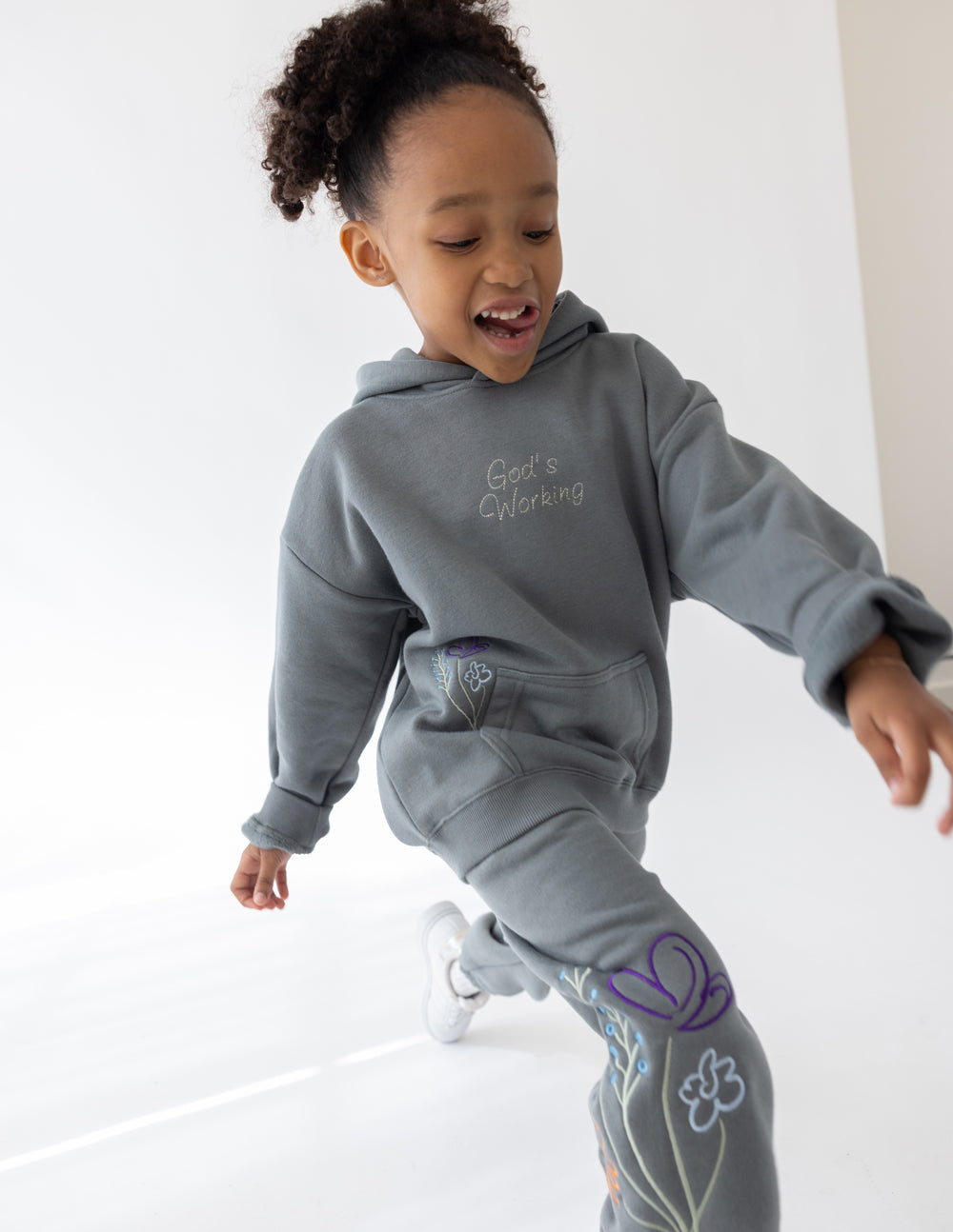 Child wearing a Sedona Sage hoodie with coordinating floral sweatpants.