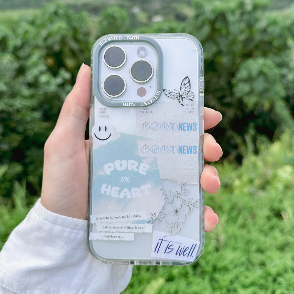 Person holding a phone with a clear case featuring text and graphics outdoors.