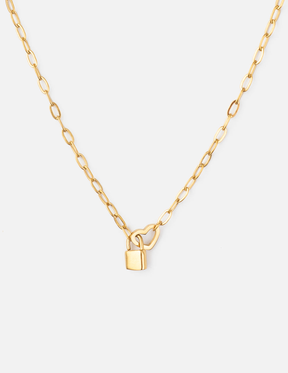 Gold-tone paperclip chain necklace with an open heart detail and a small padlock charm on a light background.