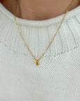Close-up of the Heart Lock Paperclip Chain Necklace worn with a white knit sweater.
