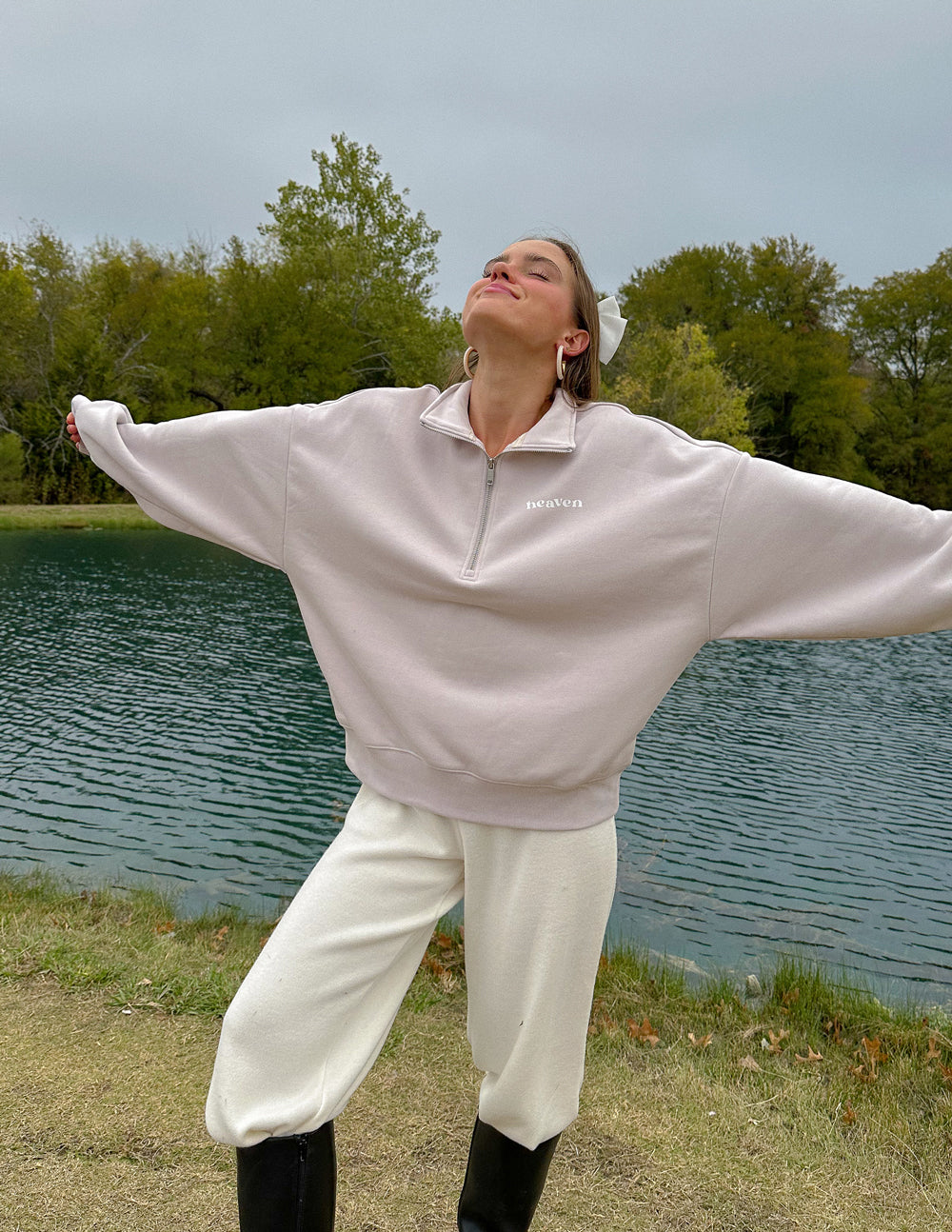 Model wearing the Grey Lilac Heaven half-zip with arms extended, showing the drop shoulder silhouette