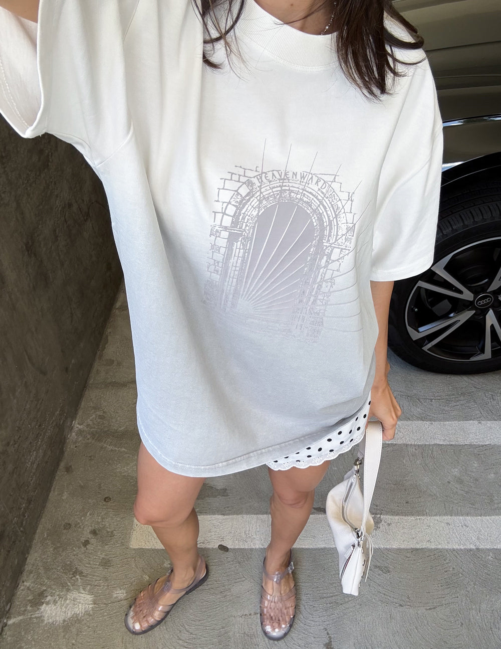 Overhead view of the Stone Grey Ombre Heavenward tee styled with white patterned shorts
