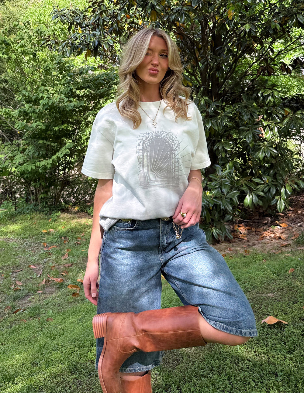 Model wearing the Heavenward Heavyweight Tee with denim shorts in a garden