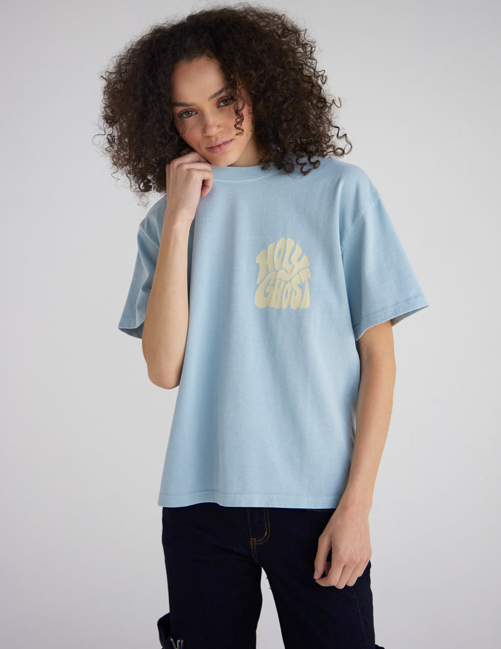 Model wearing the Holy Ghost Sterling Blue heavyweight tee with a small yellow chest graphic