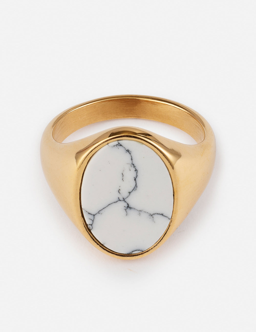 Gold-tone ring featuring an oval white howlite stone with gray veining on a white background