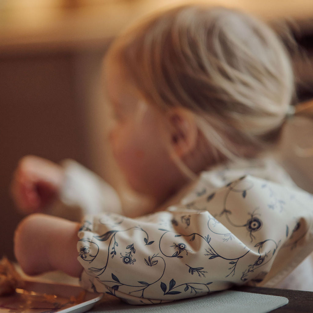Child sitting on a couch with a blurred background