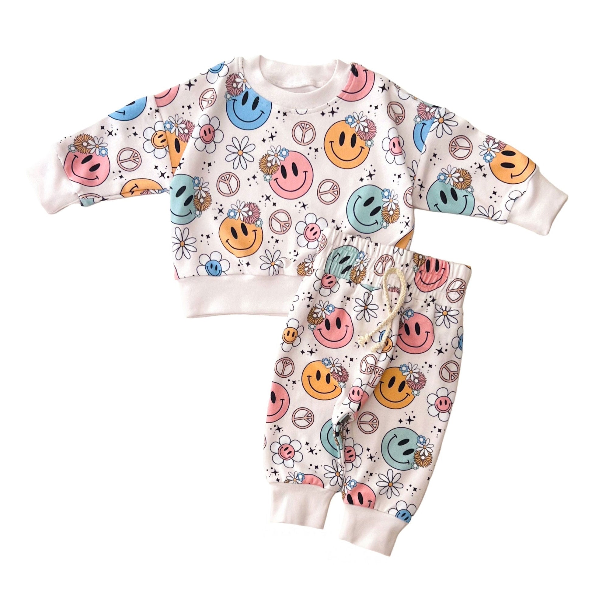 Baby outfit with smiley face pattern on a white background