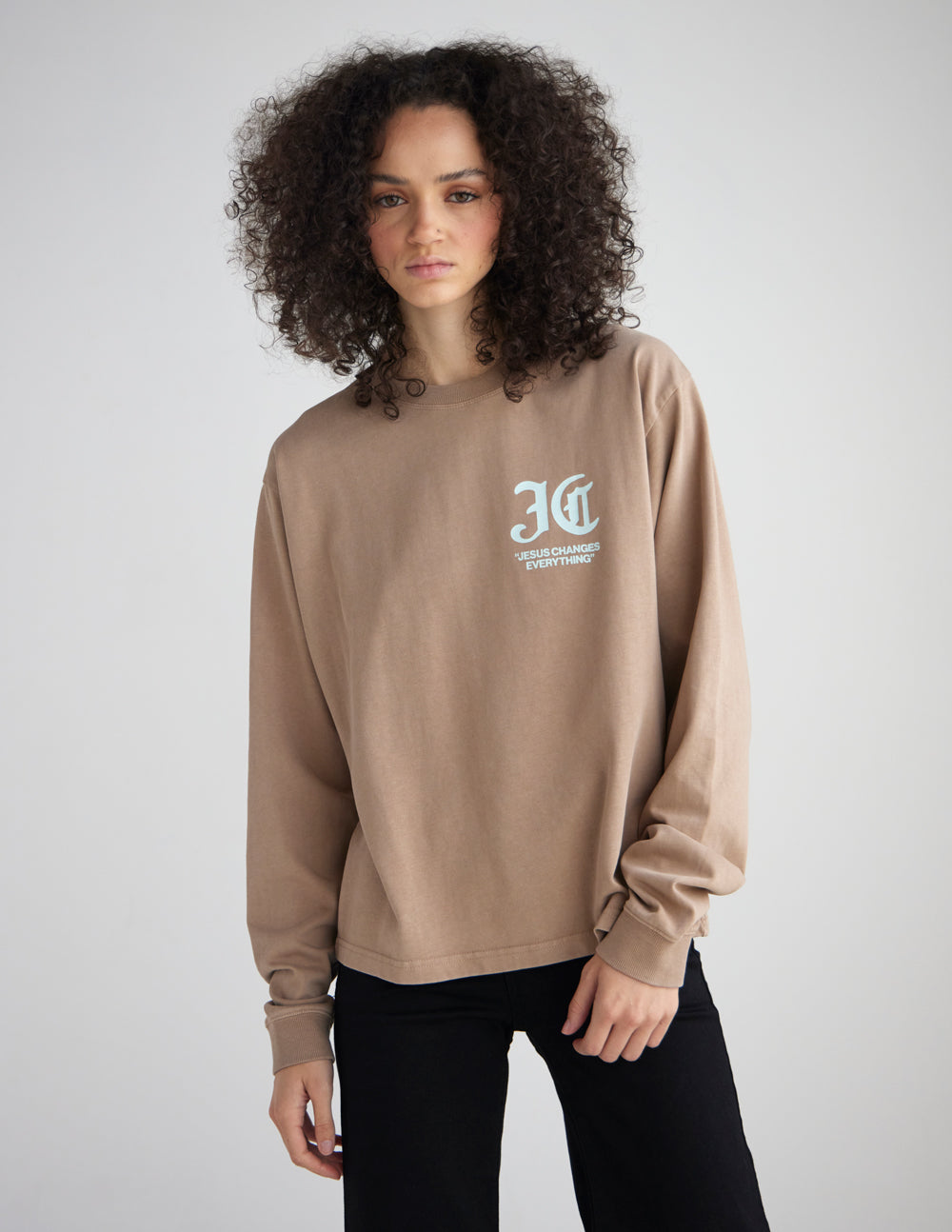 Model wearing the Jesus Changes Everything dune long sleeve tee with black pants