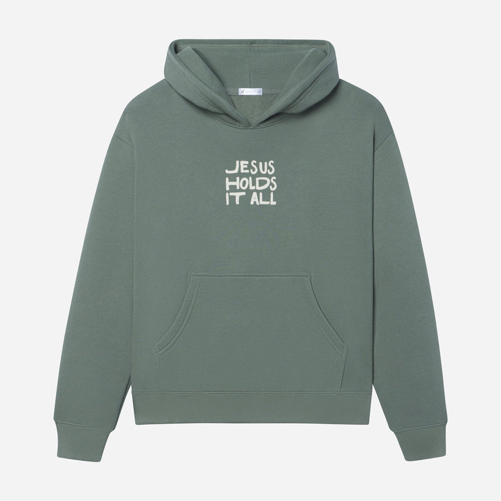 Green hoodie with 'Jesus Holds It All' text on a white background