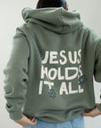 Jesus Holds It All Unisex Hoodie | Faith Based Relaxed Hoodie