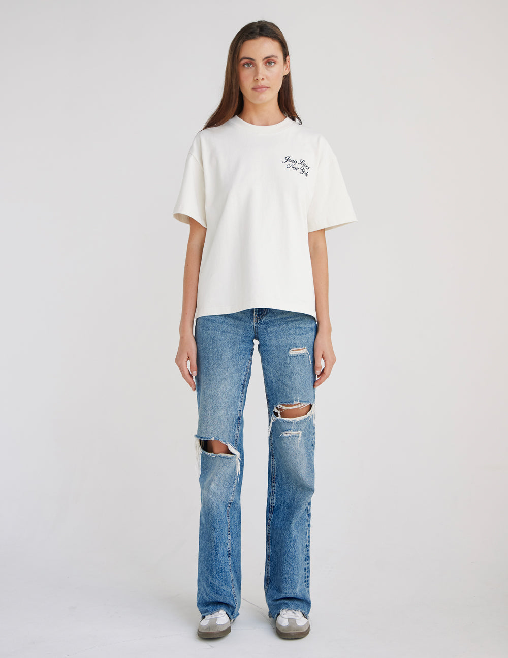 Full-length front view of the Jesus Loves New York heavyweight tee styled with jeans.