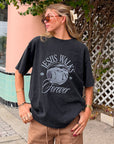 Model wearing black Jesus Walks heavyweight graphic tee with brown pants