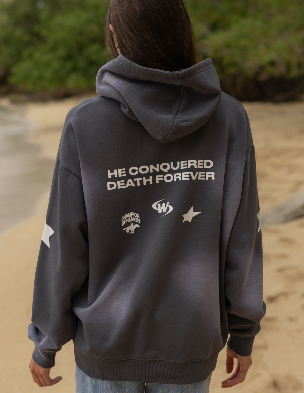 Back detail of the Black Tide Jesus Wins Hoodie showing He Conquered Death Forever lettering and small graphics