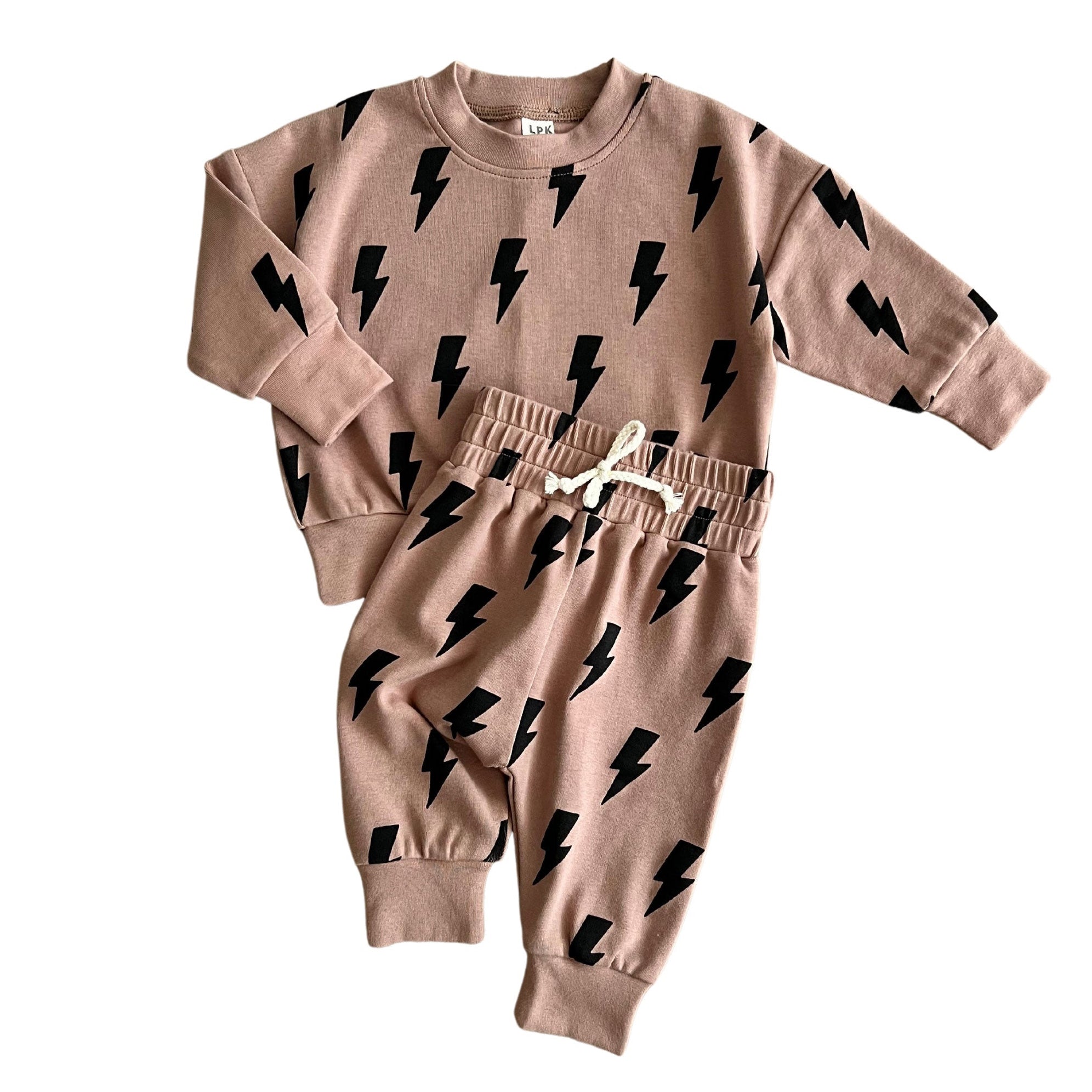 Children's sweatshirt and pants set with black bolt pattern on a beige background