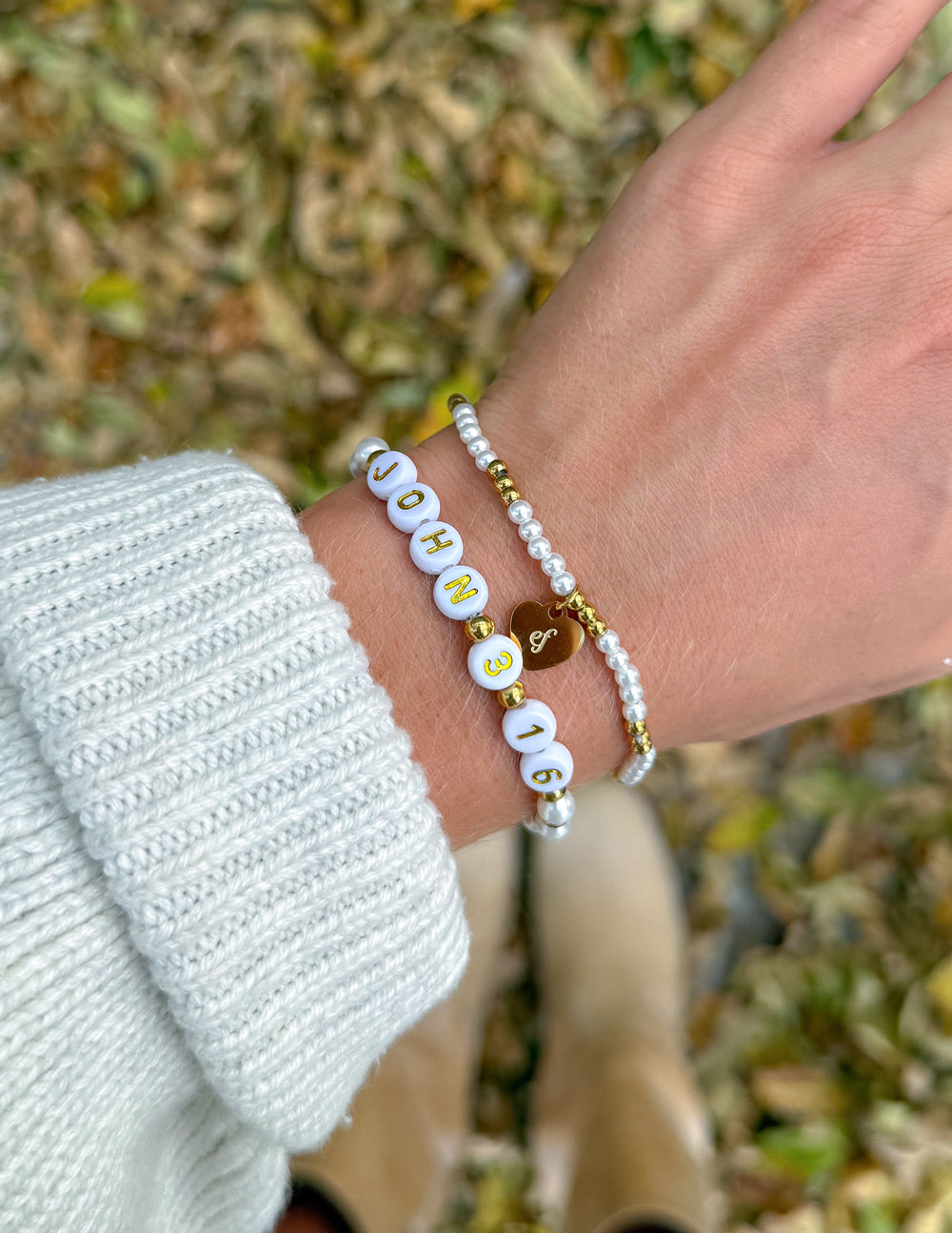 John 3:16 beaded bracelet set worn together on a wrist with a light knit sleeve outdoors